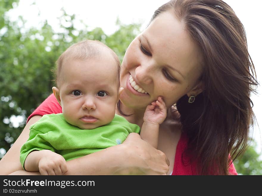 Newborn in the arms of mother nature on the background