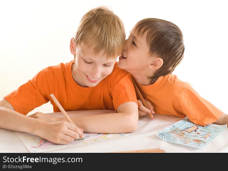 Two brothers paint on a white background