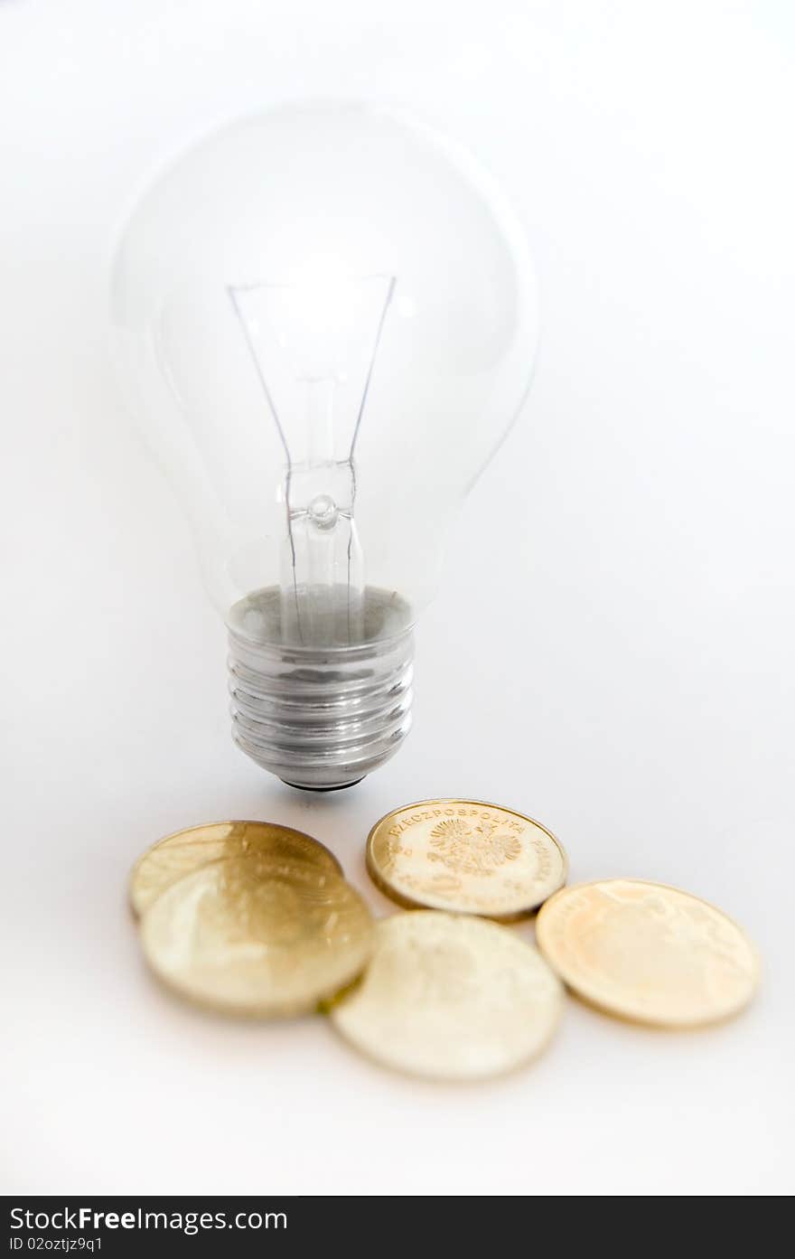 Bulb on isolated background with money. Bulb on isolated background with money.