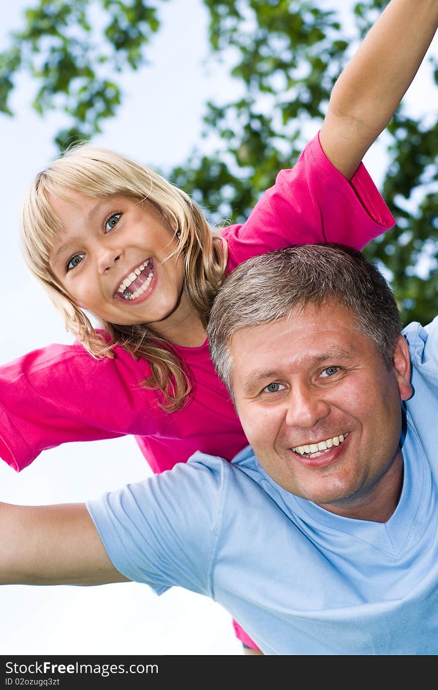 Happy father and daughter in summer park