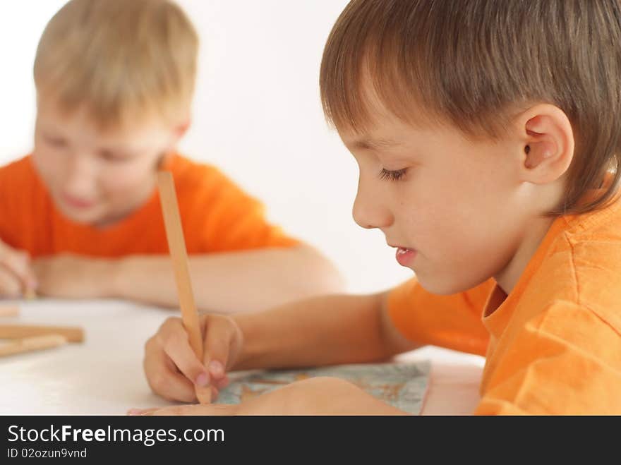 Two brothers paint on a white background