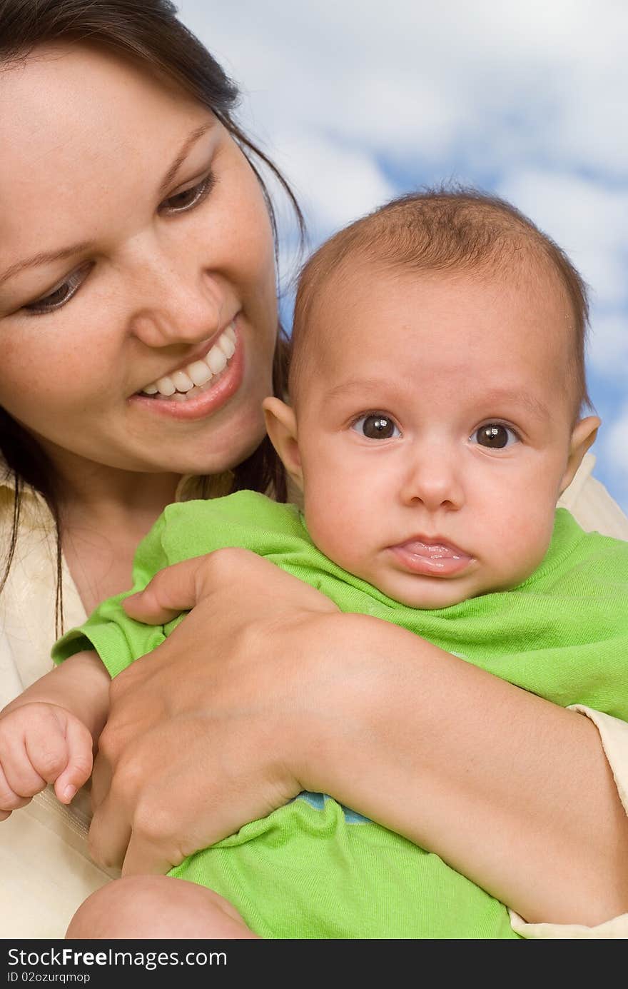 Happy mother stands and holds the baby