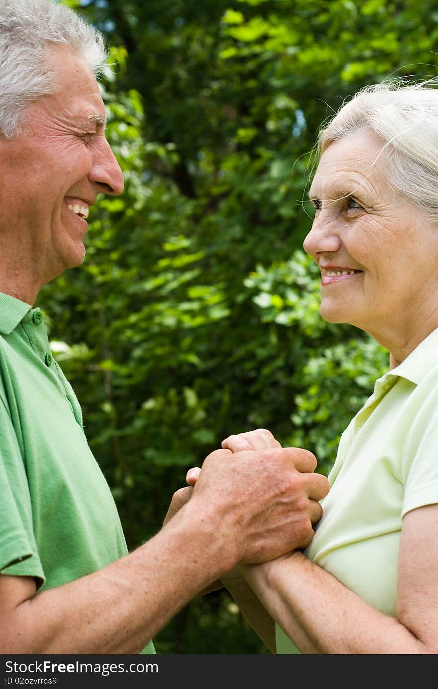 Happy elderly couple in a summer park