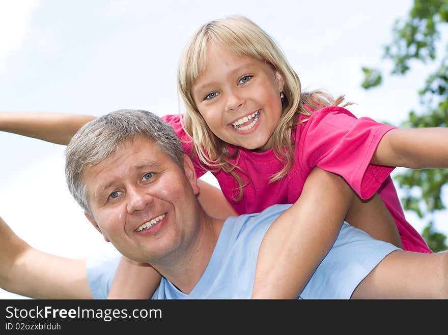 Happy father and daughter in summer park