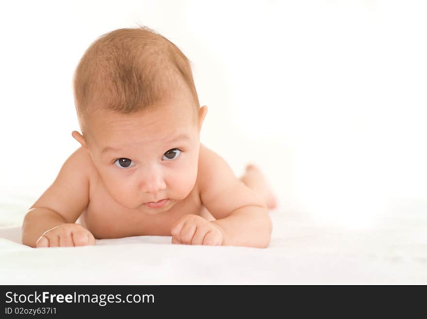 Beautiful newborn baby on a white