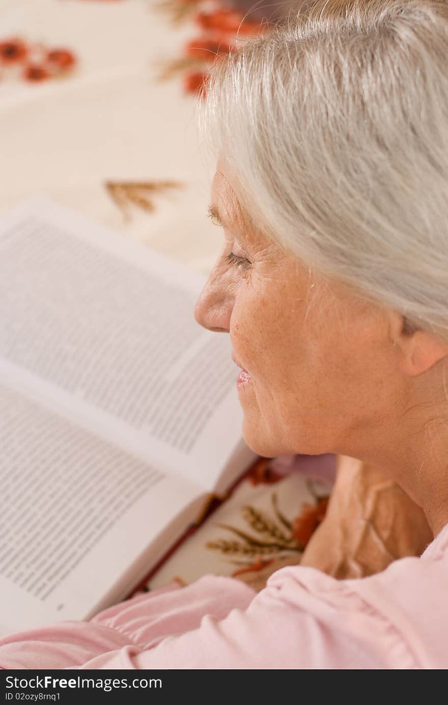 Pretty elderly woman standing on white