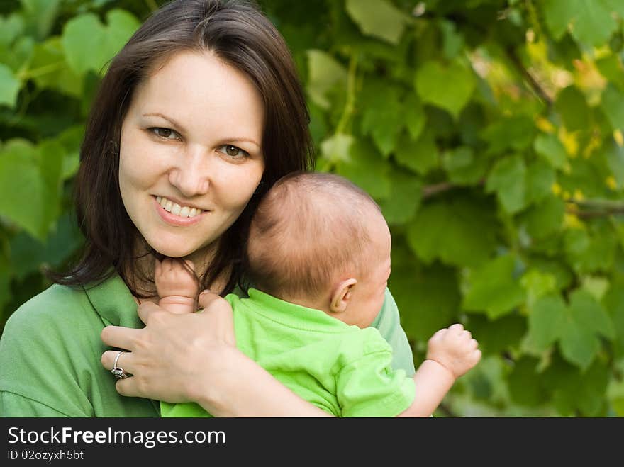 Newborn in the arms of mother nature on the background