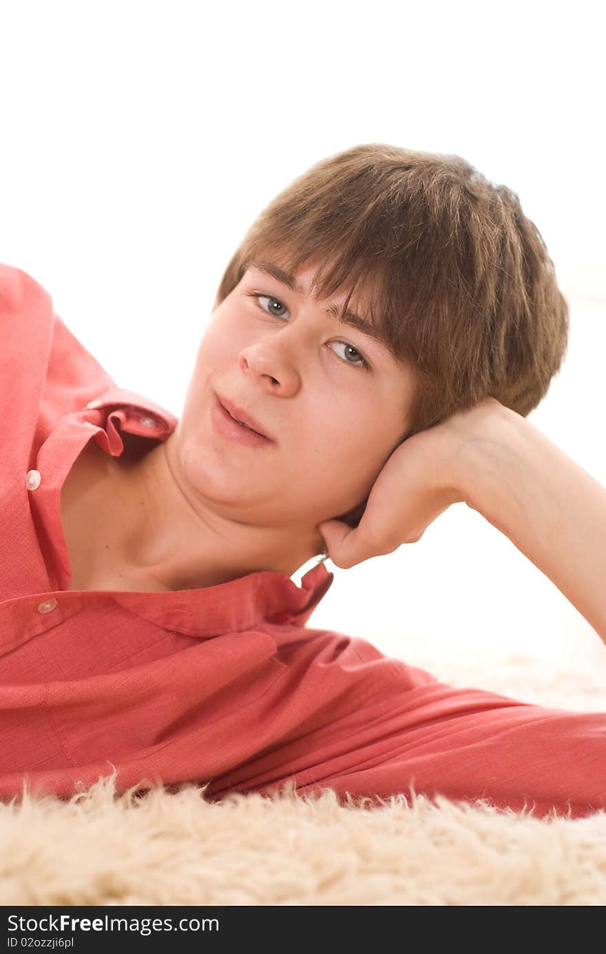 Beautiful teenager in a red shirt on a white