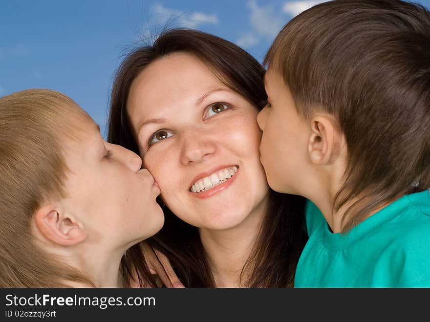 Mother with children at the background of the sky