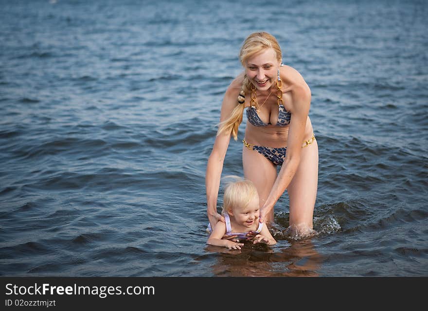 Mother with the baby  on the beach. Mother with the baby  on the beach