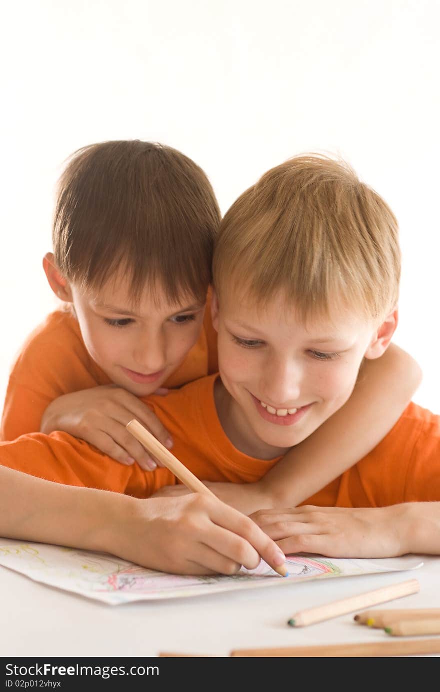 Two brothers paint on a white background