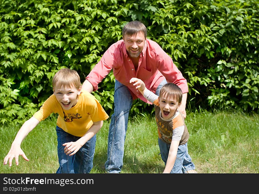 Father playing with  two children on nature. Father playing with  two children on nature