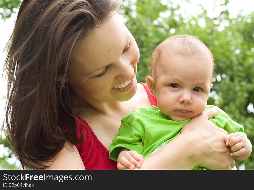 Newborn in the arms of mother nature on the background