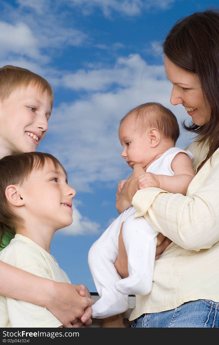 Young mother with three children standing together