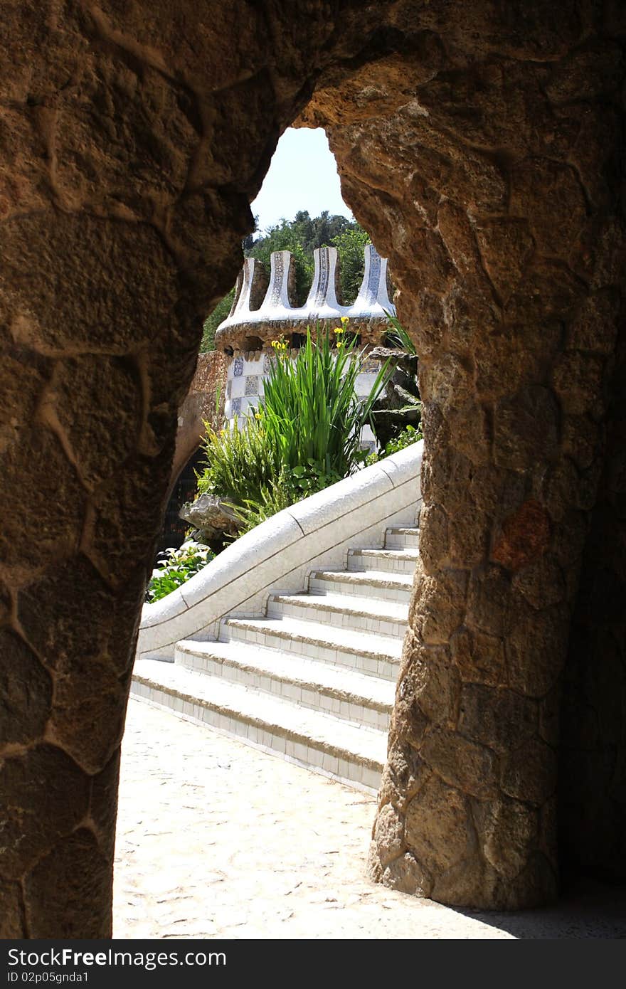 The park is seen through the stone arch