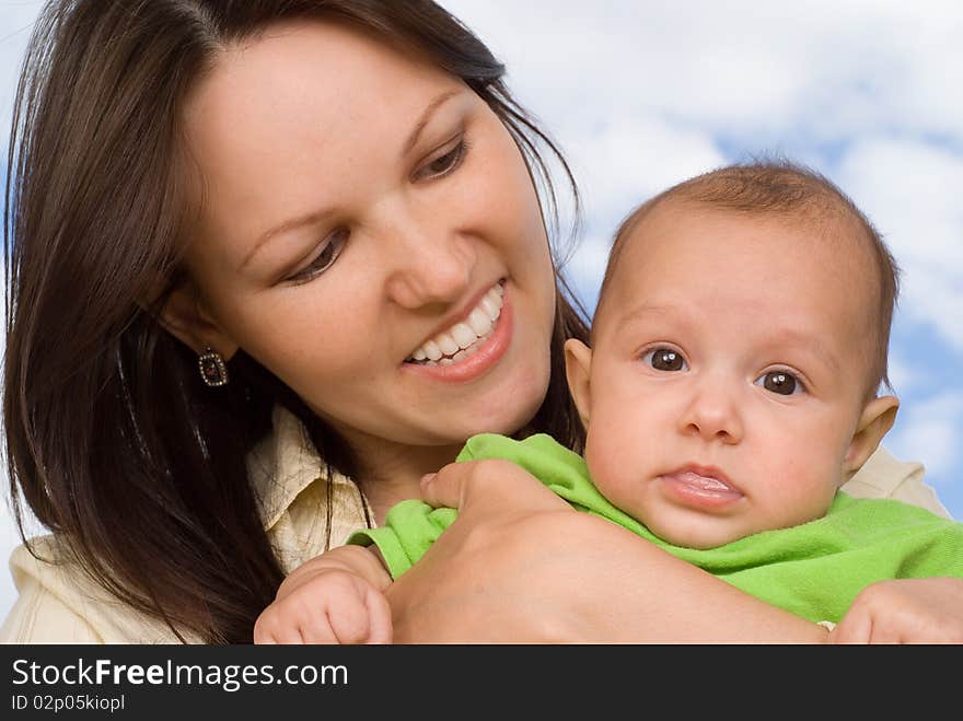 Happy mother stands and holds the baby