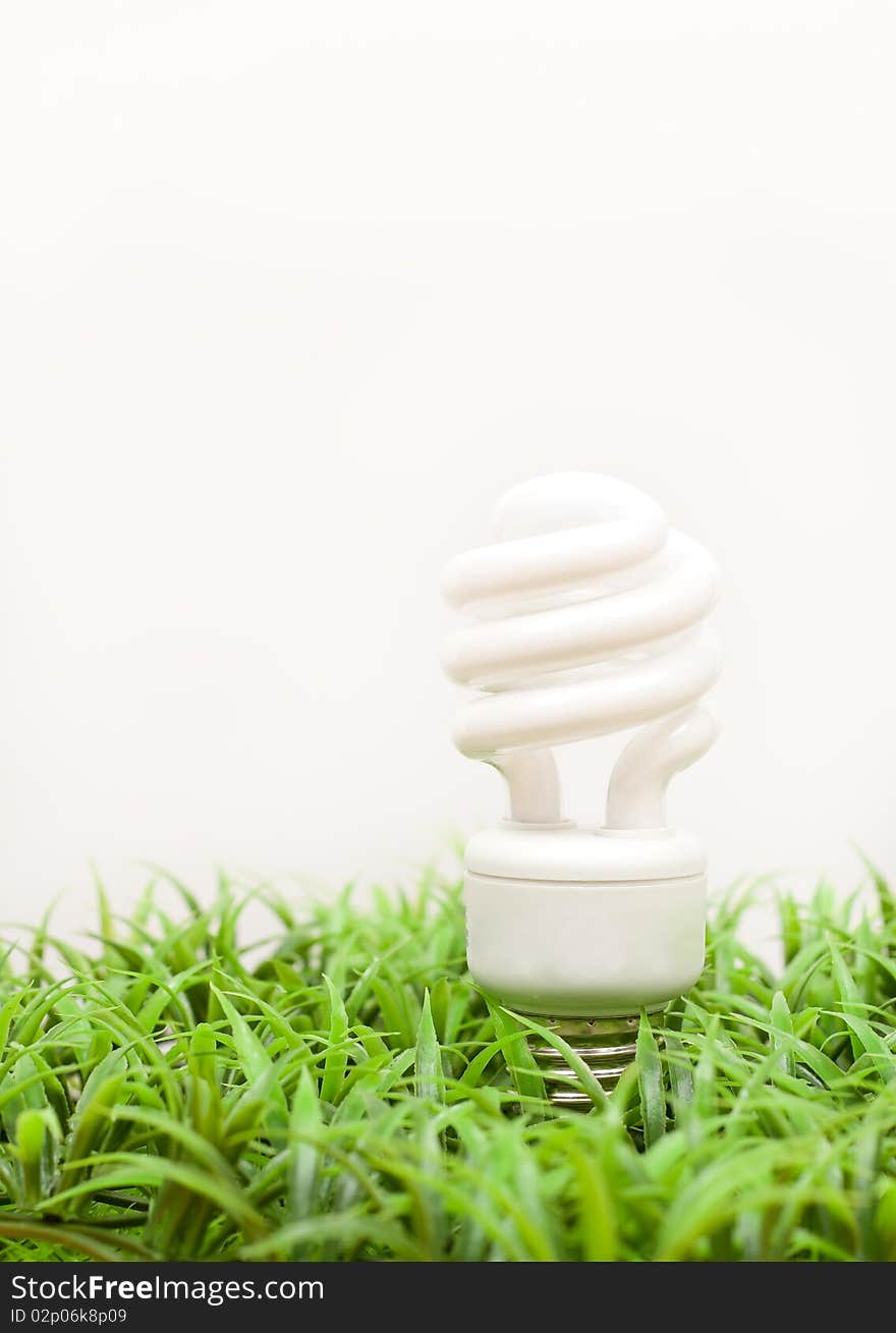 Energy Saving Light-Bulb In Fake Grass. Energy Saving Light-Bulb In Fake Grass