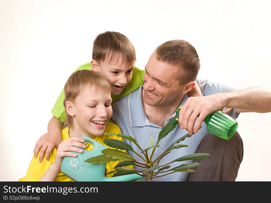 Father and children  watering flower