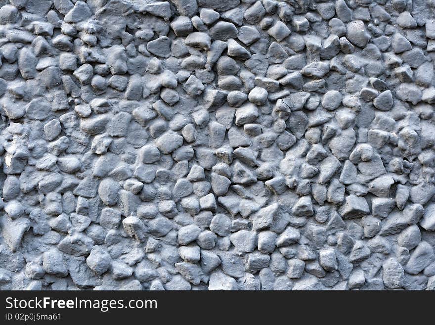 Factured grey grunge cement wall. May use as a texture or background.