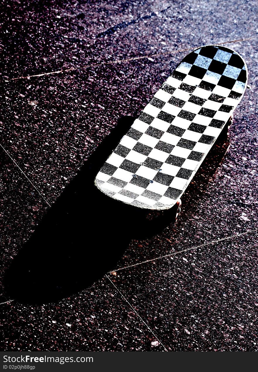 Skateboard placed on tile on outside