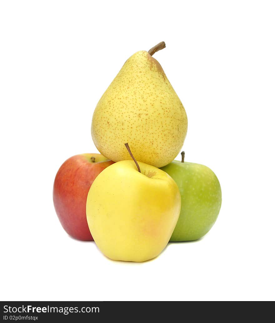 Pear balances on top of three apples. Pear balances on top of three apples