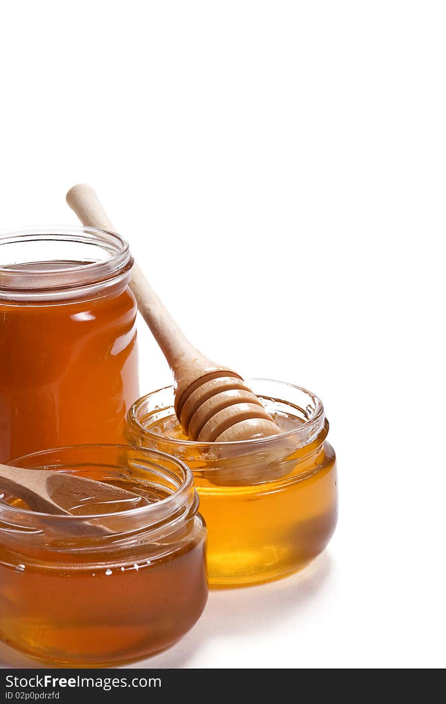 Isolated glass pots of honey