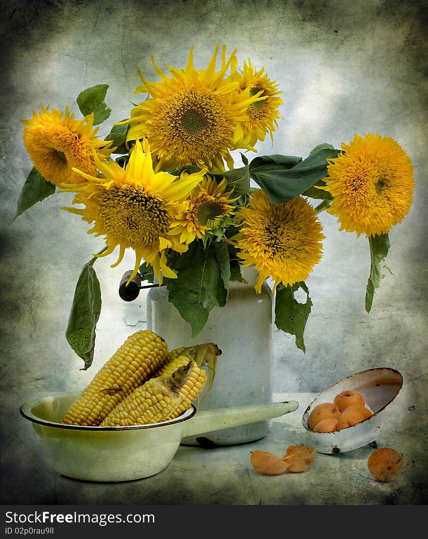 The bouquet of sunflowers is costed in a can, a corn and some apricot lie alongside. The bouquet of sunflowers is costed in a can, a corn and some apricot lie alongside