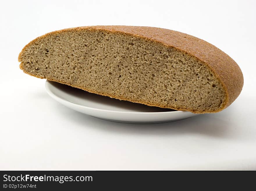 Bread on a plate on a white background. Bread on a plate on a white background