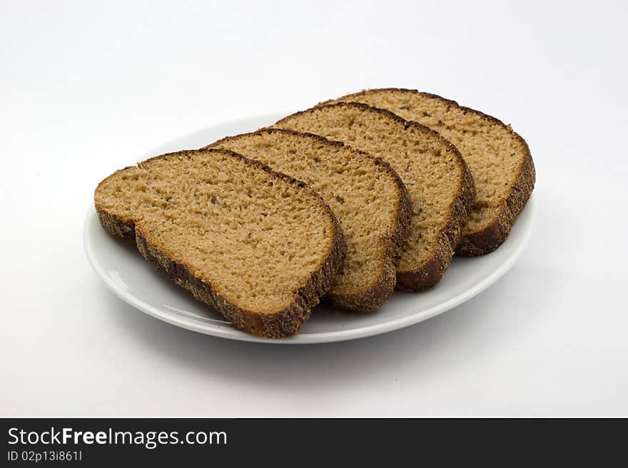 Bread on a plate on a white background. Bread on a plate on a white background