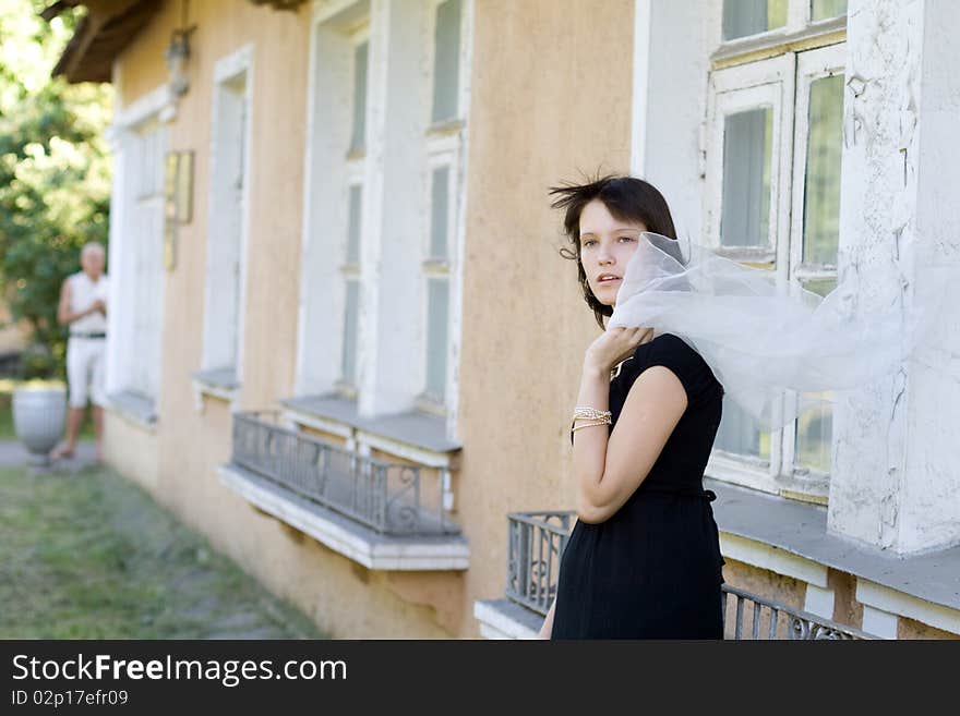 Girl standing in front of an old house