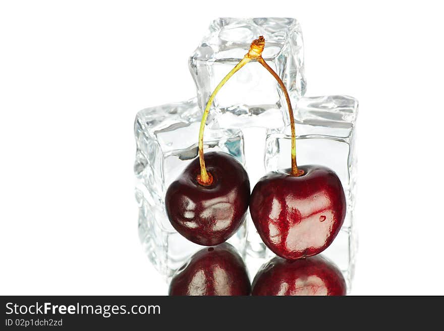 Fresh berries and cubes of ice on white background