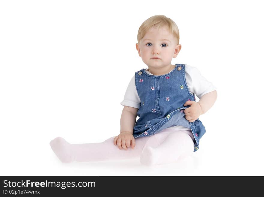 Dinky little girl sitting on white background.