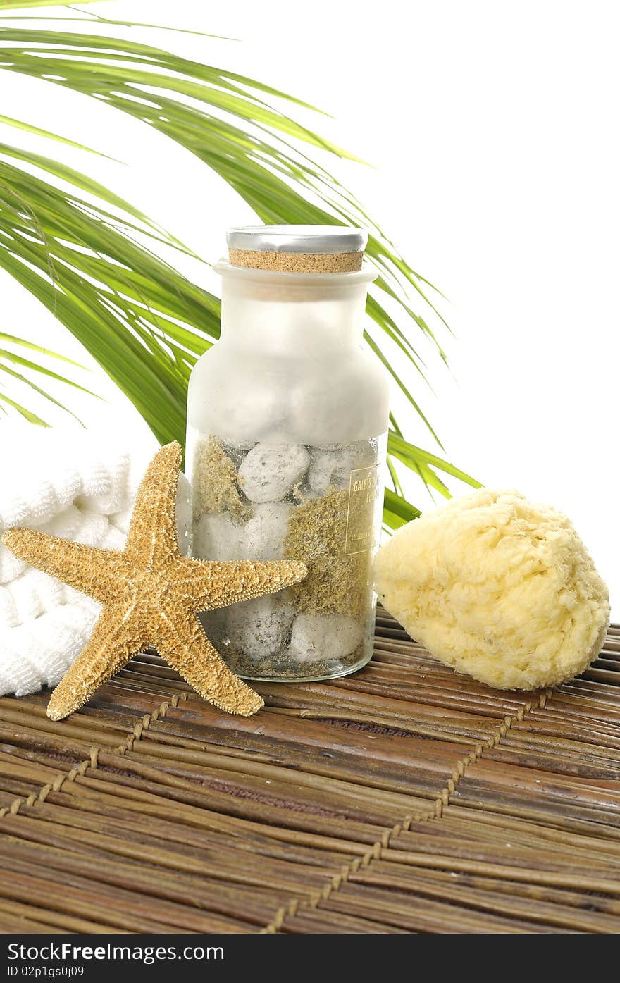 Towel and seashells on bamboo mat. Towel and seashells on bamboo mat