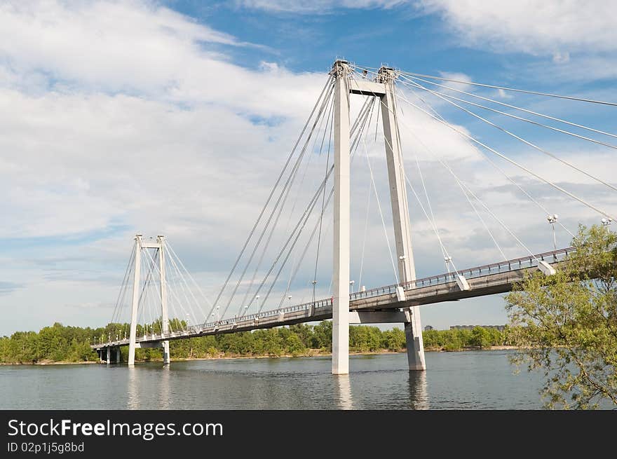 Bridge through river on background cloud