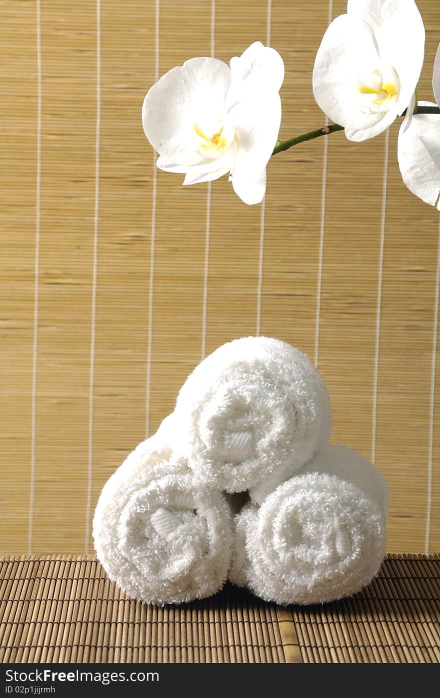 Spa towel and  bright orchid on mat