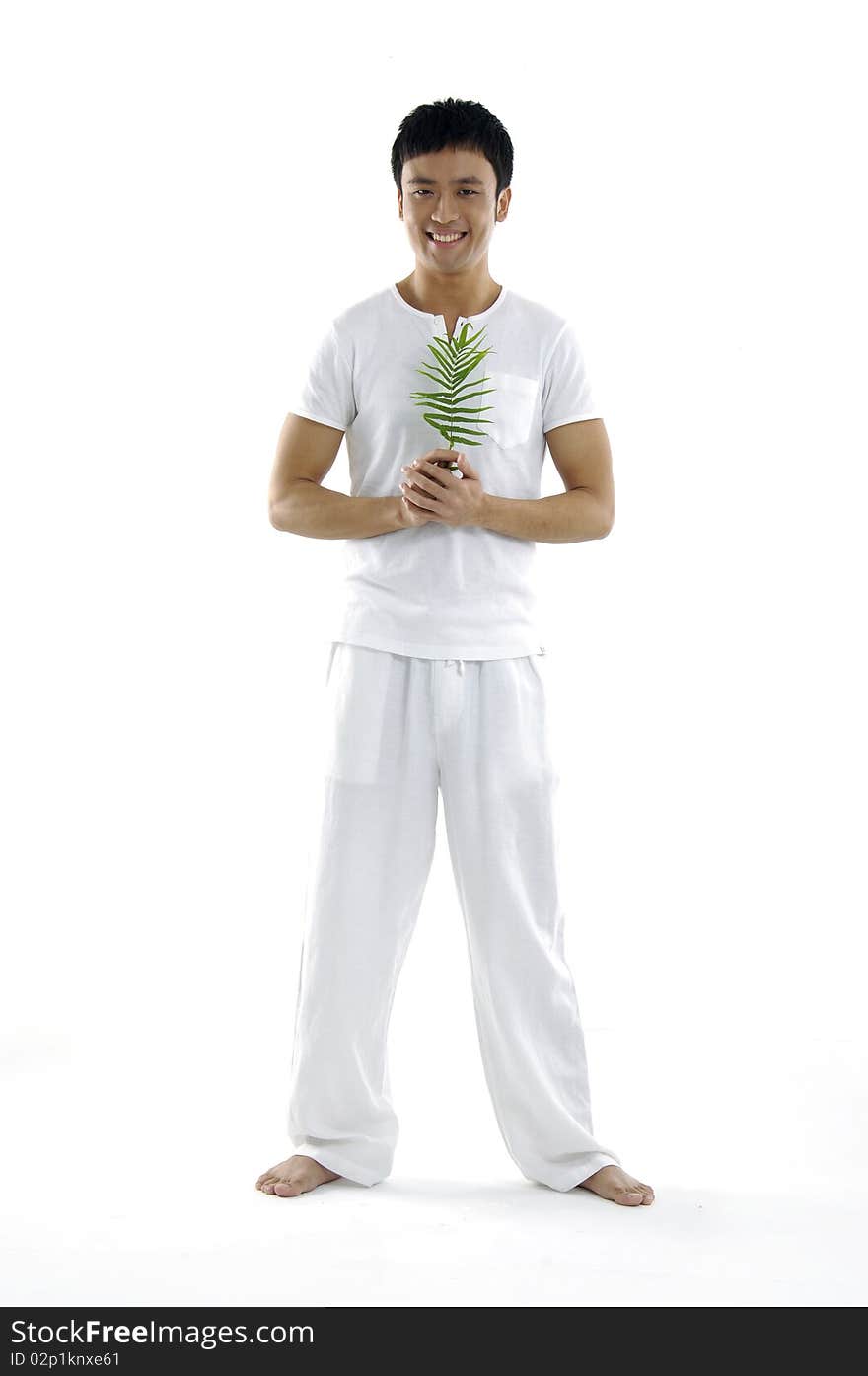 Isolated young man holding a fern