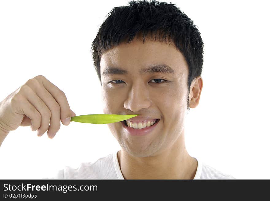 Close up asian young man holding a green leaf