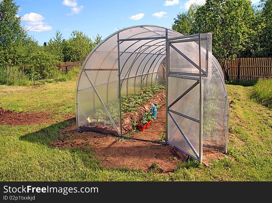 New hothouse in summer garden. New hothouse in summer garden