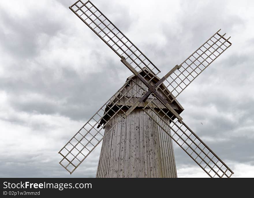 Old windmill against cloudy sky. close-up