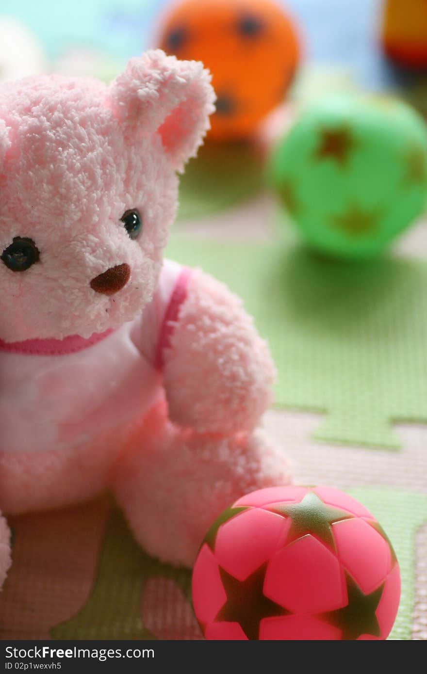 Pink teddy bear and ball