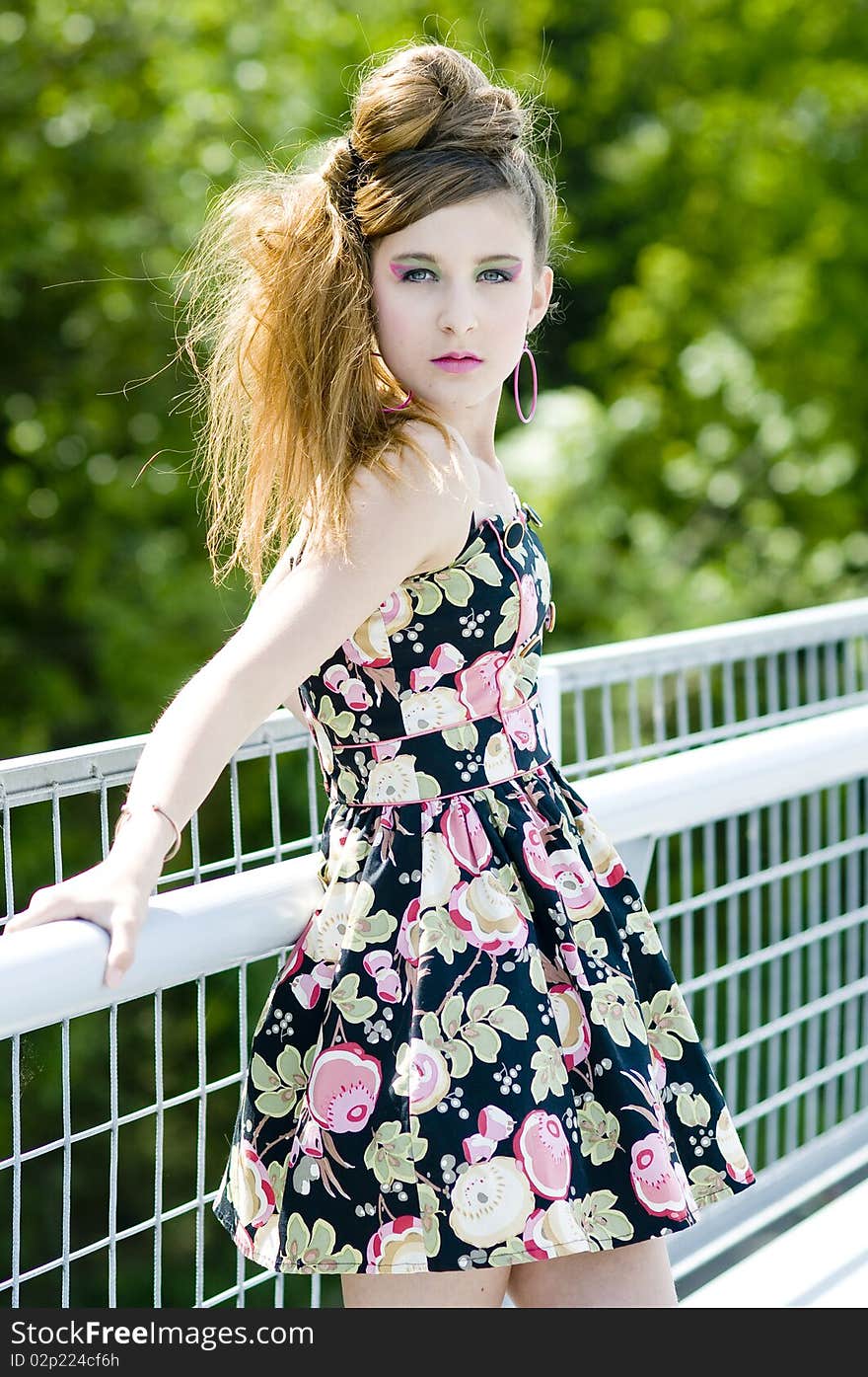 Teenager girl model presenting clothes in the park natural background