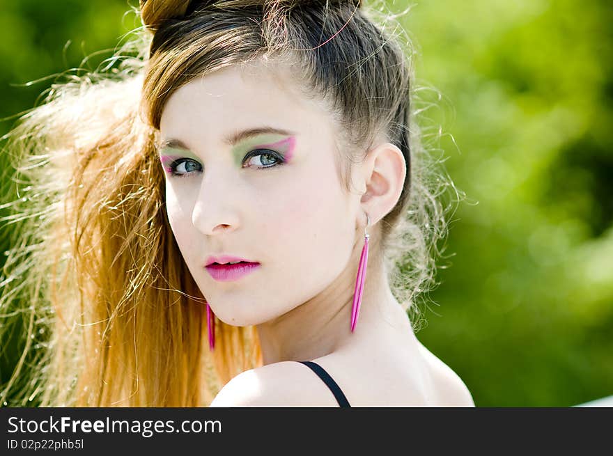 Closeup teenage girl model presenting clothes in the park natural background. Closeup teenage girl model presenting clothes in the park natural background