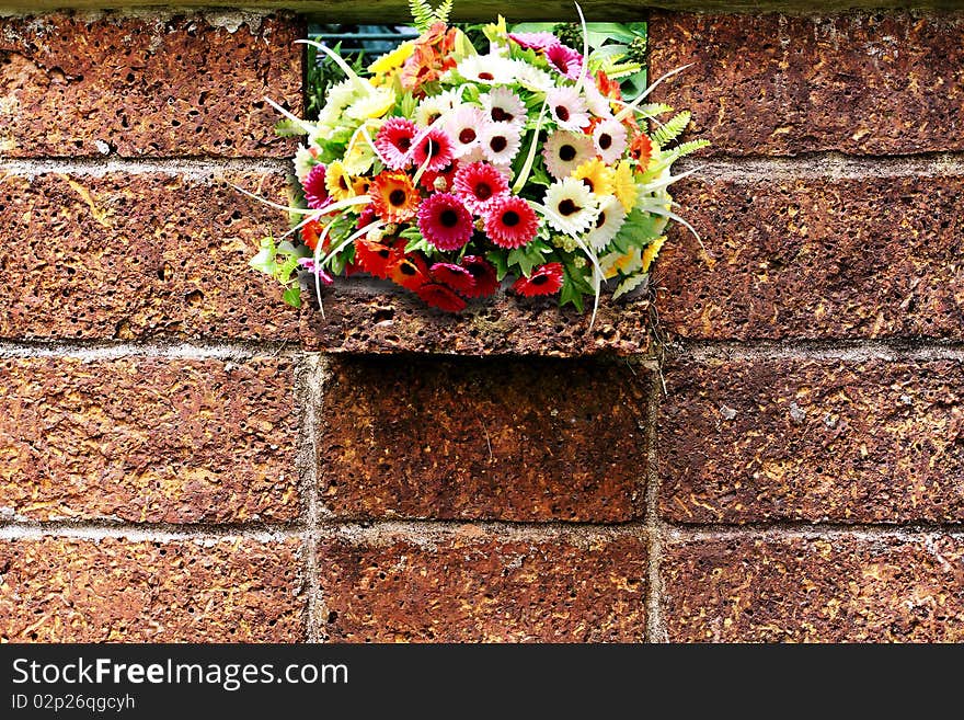 Stone background wall with colorful flowers