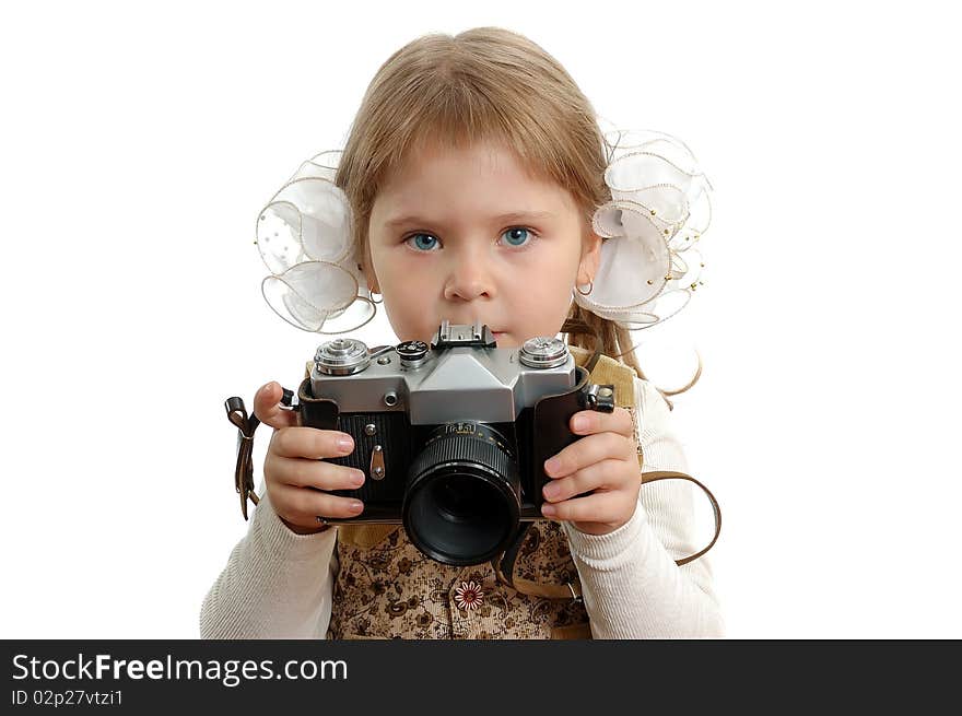 The little girl with the photo camera on the white