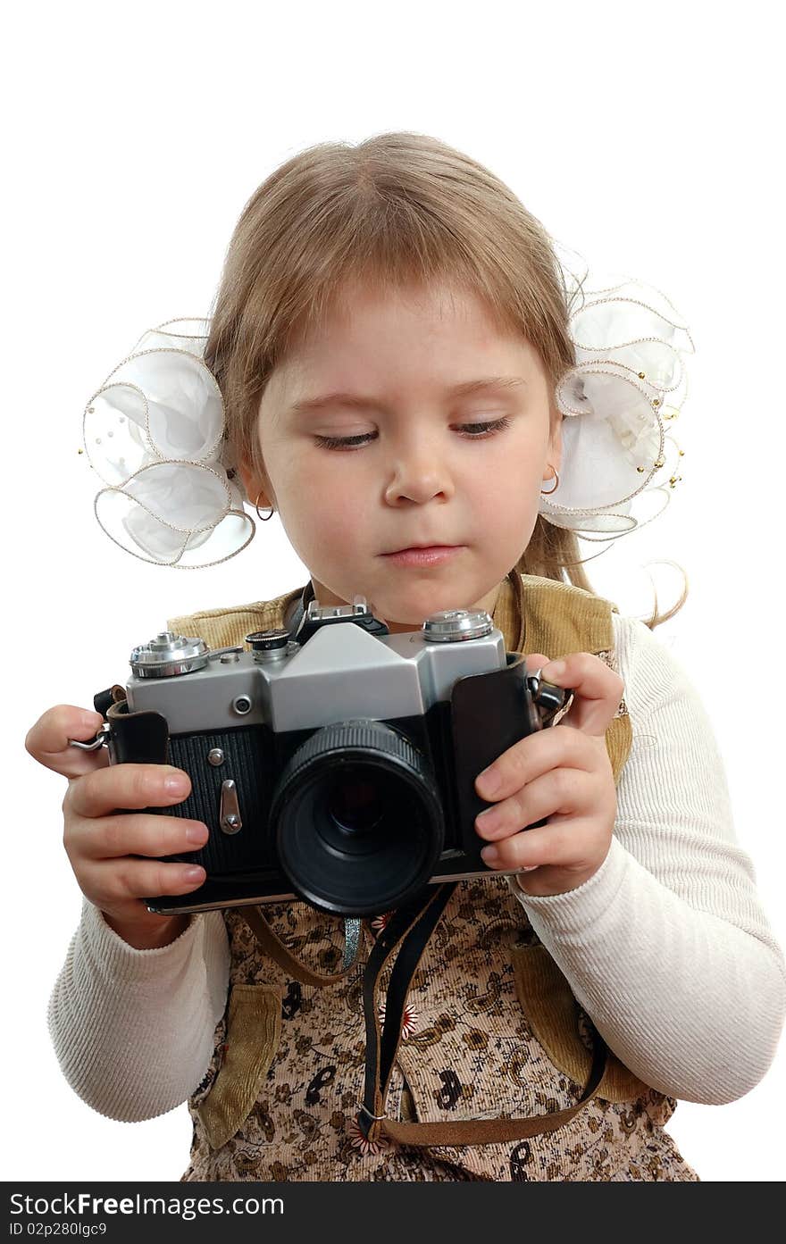 The little girl with the photo camera on the white