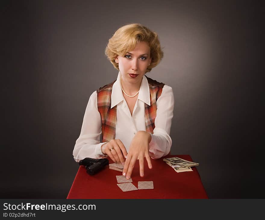 The pretty woman with cards on a grey background