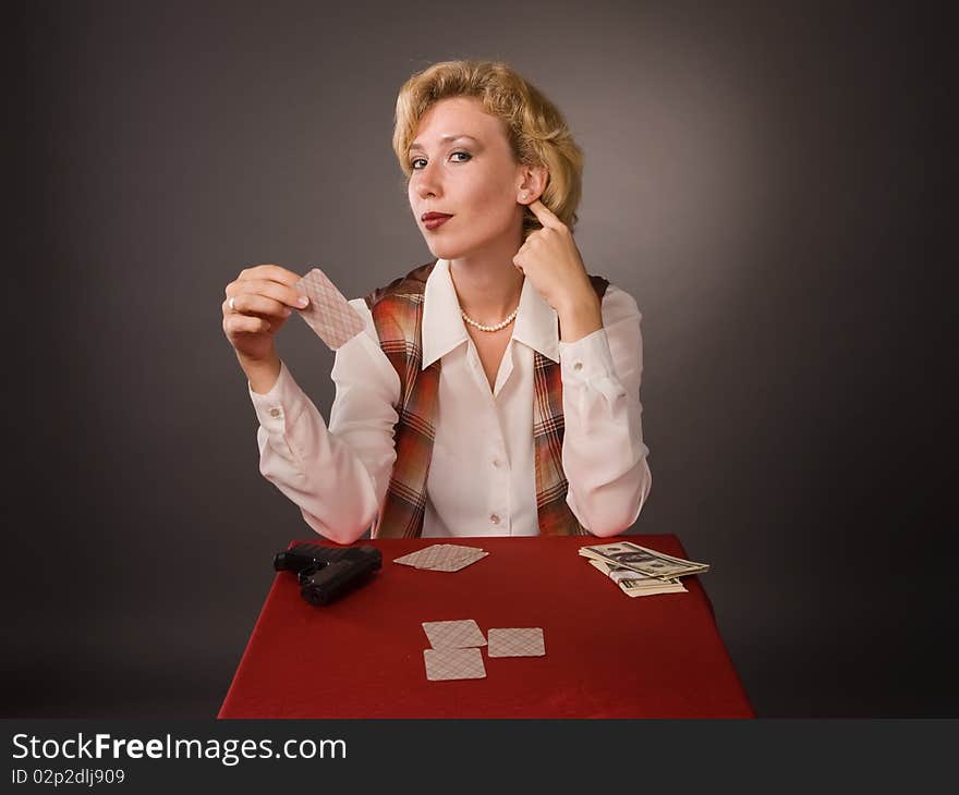 The pretty woman with cards on a grey background