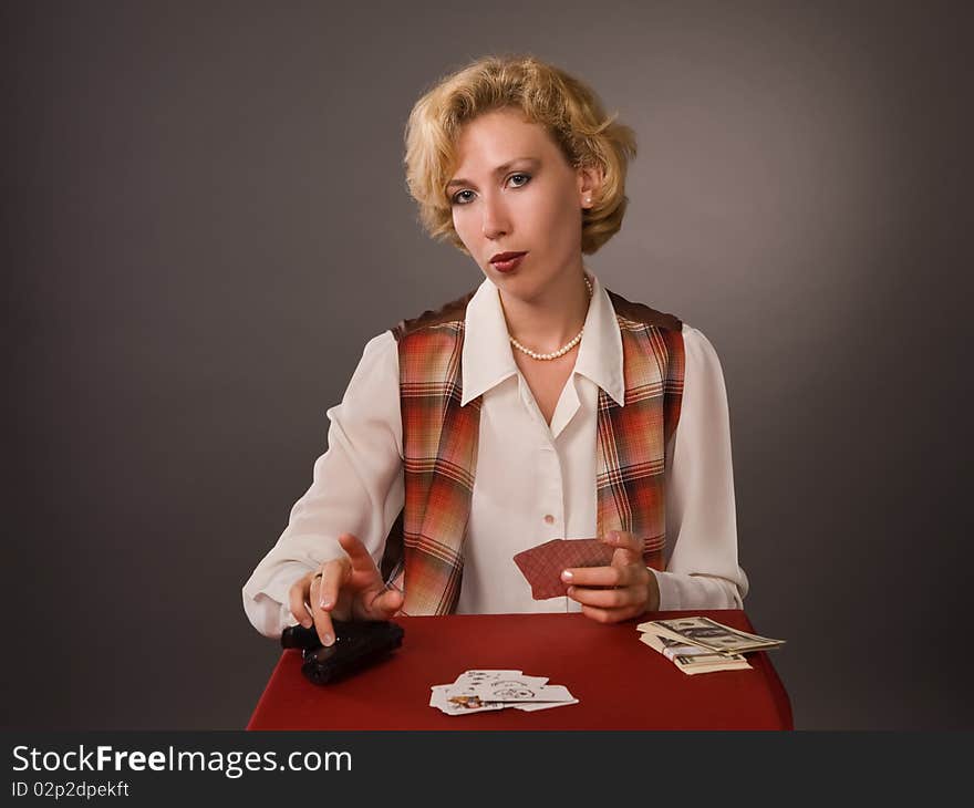 The pretty woman with cards on a grey background