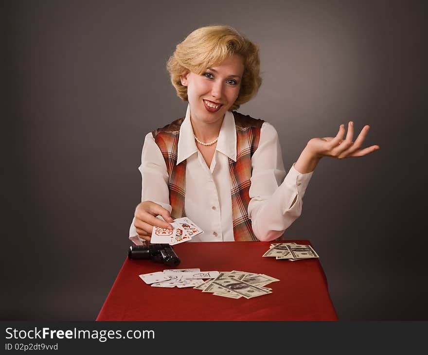 The pretty woman with cards on a grey background