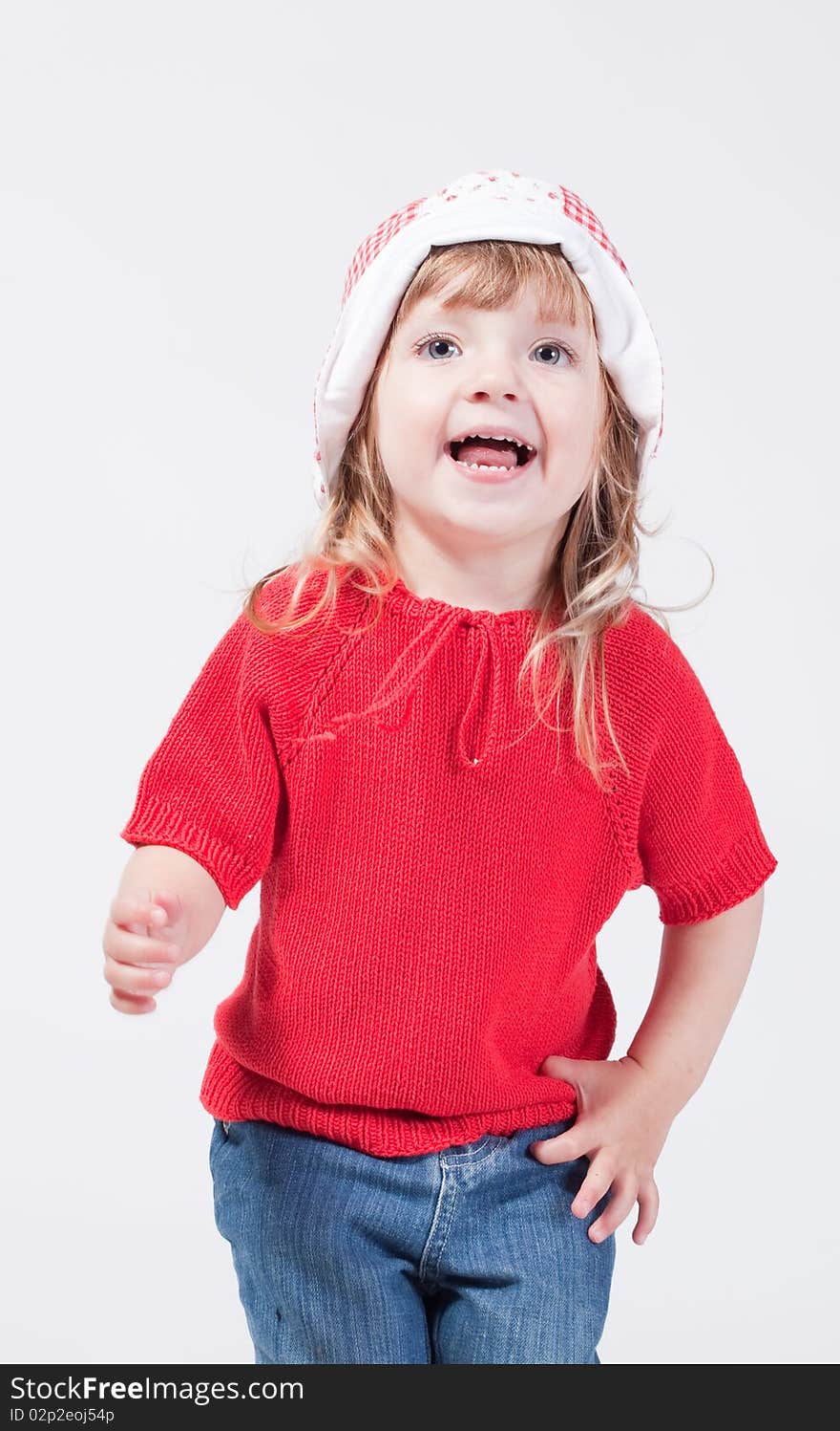 Studio portrait of cute happy smiling child in hat